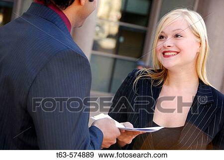 35 yr old ethnic business man handing file folder to 25 yr old caucasian business woman View Large Photo Image Stock Photo - 35 yr old ethnic business man handing file folder to 25 yr old caucasian business woman. Fotosearch