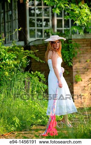 36 year old brunette woman in a white dress standing in an overgrown yard acting for the camera View Large Photo Image Stock Image - 36 year old brunette woman in a white dress standing in an overgrown yard acting for the camera. Fotosearch