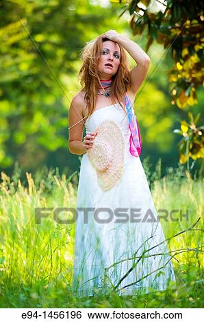 36 year old brunette woman in a white dress standing in an overgrown yard acting for the camera View Large Photo Image Stock Photograph - 36 year old brunette woman in a white dress standing in an overgrown yard acting for the camera. Fotosearch