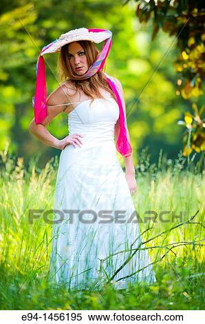 36 year old brunette woman in a white dress standing in an overgrown yard acting for the camera View Large Photo Image Stock Photography - 36 year old brunette woman in a white dress standing in an overgrown yard acting for the camera. Fotosearch