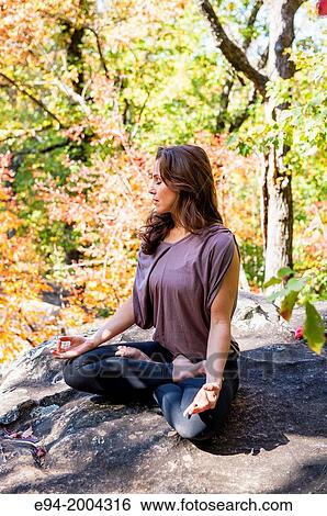 37 year old brunette woman wearing fitness clothes doing a yoga pose in a forest setting. View Large Photo Image Stock Photograph - 37 year old brunette woman wearing fitness clothes doing a yoga pose in a forest setting.. Fotosearch