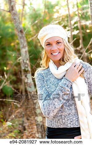 39 year old blond woman wearing a sweater, mini-skirt and boots walking in the forest in the fall. View Large Photo Image Stock Photo - 39 year old blond woman wearing a sweater, mini-skirt and boots walking in the forest in the fall.. Fotosearch