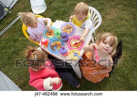 4 children camping, sitting round a table eating dinner View Large Photo Image Stock Photo - 4 children camping, sitting round a table eating dinner. Fotosearch