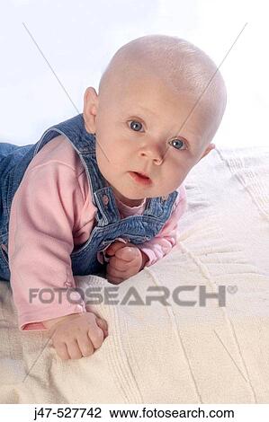 4 month old baby girl, looking into camera, lying on her tummy View Large Photo Image Stock Image - 4 month old baby girl, looking into camera, lying on her tummy. Fotosearch