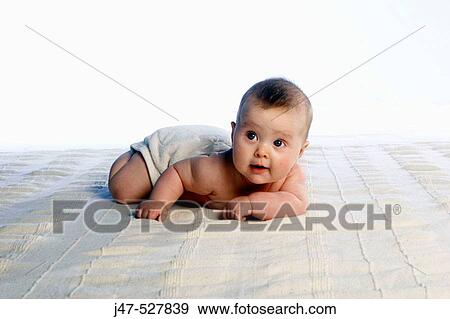 4 month old baby, lying on her tummy smiling off camera, lifting her head up View Large Photo Image Stock Photo - 4 month old baby, lying on her tummy smiling off camera, lifting her head up. Fotosearch