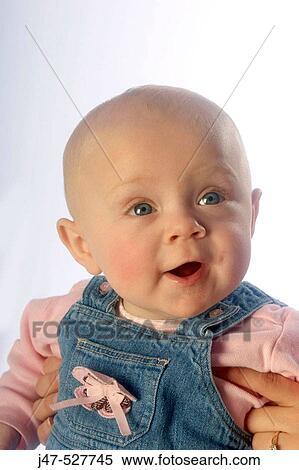 Stock Photography - 4 month old baby smiling off camera. Fotosearch