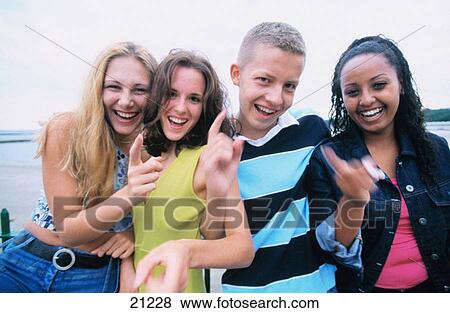 4 teenagers, 3 girls & 1 boy, laughing and pointing at the camera View Large Photo Image Stock Photo - 4 teenagers, 3 girls & 1 boy, laughing and pointing at the camera. Fotosearch