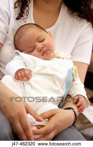 4 week old baby asleep on her mothers knee View Large Photo Image Stock Image - 4 week old baby asleep on her mothers knee. Fotosearch