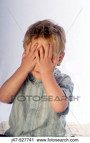 4 year old boy coverng his face with his hands View Large Photo Image Stock Image - 4 year old boy coverng his face with his hands. Fotosearch