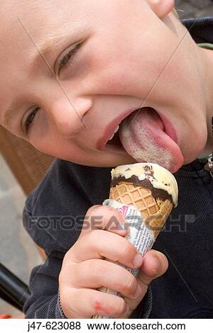4 year old boy eating an icecream, licking it, close up headshot. View Large Photo Image Stock Photo - 4 year old boy eating an icecream, licking it, close up headshot.. Fotosearch