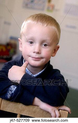4 year old boy smiling into camera at nursery View Large Photo Image Stock Photo - 4 year old boy smiling into camera at nursery. Fotosearch