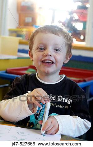 4 year old boy smiling into camera at nursery, holding a pen View Large Photo Image Stock Photograph - 4 year old boy smiling into camera at nursery, holding a pen. Fotosearch