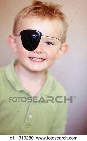 Stock Image - 4 year old boy wearing pirate eye patch. Fotosearch