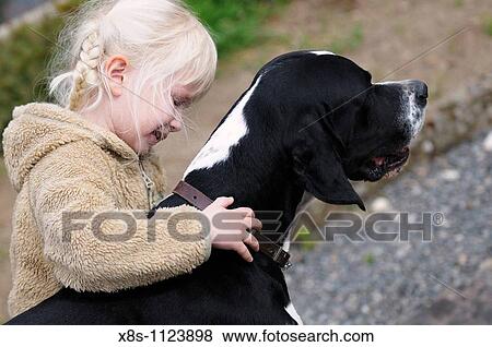 Stock Photo - 4 year old child hugging her pet dog. Fotosearch