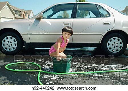 4 year old Chinese girl washing car... or sort of. View Large Photo Image Stock Image - 4 year old Chinese girl washing car... or sort of.. Fotosearch