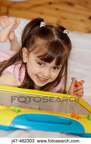 4 year old girl drawing, smiling into camera. View Large Photo Image Stock Image - 4 year old girl drawing, smiling into camera.. Fotosearch
