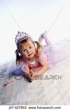 4 year old girl dressed up as a fairy lying on the floor, with her hands together infront of her View Large Photo Image Stock Image - 4 year old girl dressed up as a fairy lying on the floor, with her hands together infront of her. Fotosearch