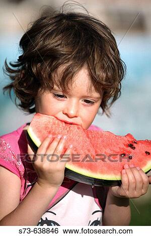 Stock Photograph - 4 year old girl eating watermelon.. Fotosearch