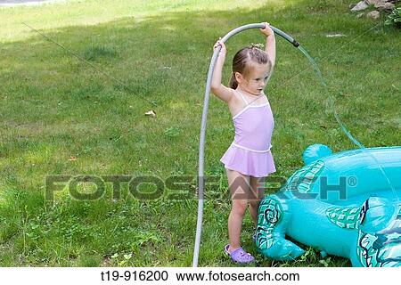 4-year old girl filling her inflatable pool with water MR View Large Photo Image Stock Image - 4-year old girl filling her inflatable pool with water MR. Fotosearch