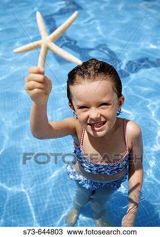 4 year old girl holding starfish. View Large Photo Image Stock Image - 4 year old girl holding starfish.. Fotosearch