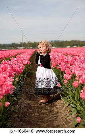 4 year old girl in black and white dress playing and smiling in a tulip fields in Skagit Valley, Washington, USA View Large Photo Image Stock Photo - 4 year old girl in black and white dress playing and smiling in a tulip fields in Skagit Valley, Washington, USA. Fotosearch
