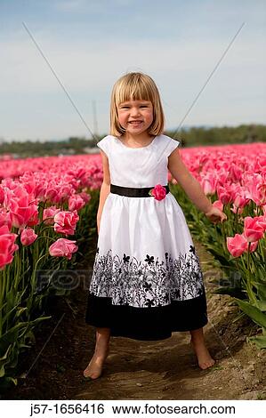 4 year old girl in black and white dress playing and smiling in a tulip fields in Skagit Valley, Washington, USA View Large Photo Image Stock Photograph - 4 year old girl in black and white dress playing and smiling in a tulip fields in Skagit Valley, Washington, USA. Fotosearch