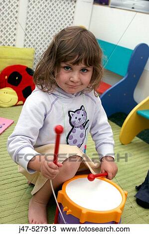 4 year old girl, looking into camera, at nursery, serious, playing a drum View Large Photo Image Stock Image - 4 year old girl, looking into camera, at nursery, serious, playing a drum. Fotosearch