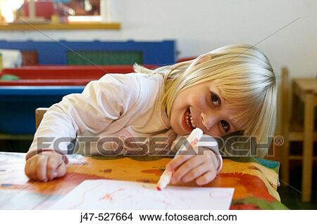 4 year old girl smiling into camera at nursery, drawing View Large Photo Image Picture - 4 year old girl smiling into camera at nursery, drawing. Fotosearch