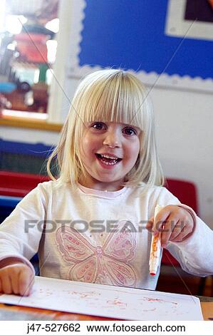 4 year old girl smiling into camera at nursery, drawing View Large Photo Image Stock Image - 4 year old girl smiling into camera at nursery, drawing. Fotosearch