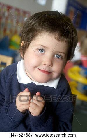 4 year old girl smiling into camera at nursery, with her hands clasped together in front of her View Large Photo Image Stock Photo - 4 year old girl smiling into camera at nursery, with her hands clasped together in front of her. Fotosearch