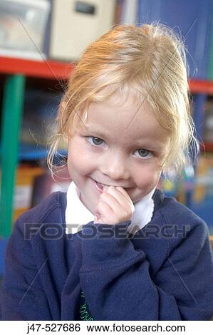 4 year old girl smiling into camera at nursery, with her hand up to her mouth View Large Photo Image Stock Photograph - 4 year old girl smiling into camera at nursery, with her hand up to her mouth. Fotosearch