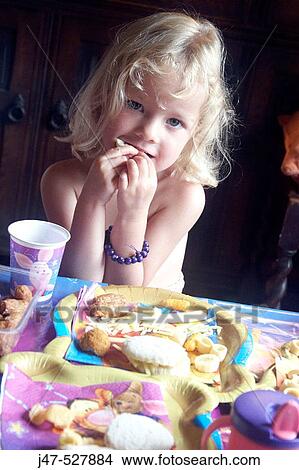 4 year old girl smilng into camera at a party, in front of all the food View Large Photo Image Picture - 4 year old girl smilng into camera at a party, in front of all the food. Fotosearch