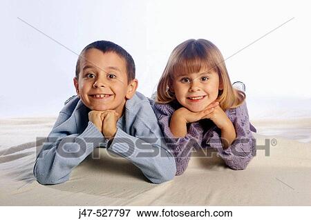 4 year old girl with blonde hair, smiling into camera, in the studio, lying on the floor with her 5, year old brother View Large Photo Image Stock Photo - 4 year old girl with blonde hair, smiling into camera, in the studio, lying on the floor with her 5, year old brother. Fotosearch