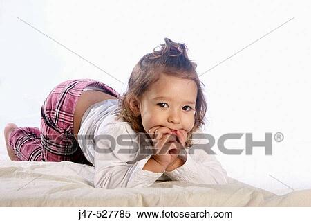 4 year old girl with blonde hair, smiling into camera, in the studio, lying on the floor, hands under her chin View Large Photo Image Stock Photography - 4 year old girl with blonde hair, smiling into camera, in the studio, lying on the floor, hands under her chin. Fotosearch