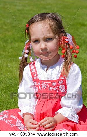 4 years old girl in red dress sitting on the grass. View Large Photo Image Picture - 4 years old girl in red dress sitting on the grass.. Fotosearch