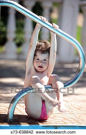 Stock Image - 4 years old girl in swimming-pool.. Fotosearch