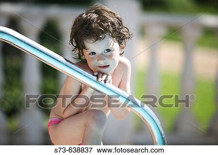 Stock Photo - 4 years old girl in swimming-pool.. Fotosearch