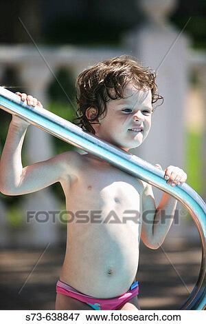Stock Photo - 4 years old girl in swimming-pool.. Fotosearch
