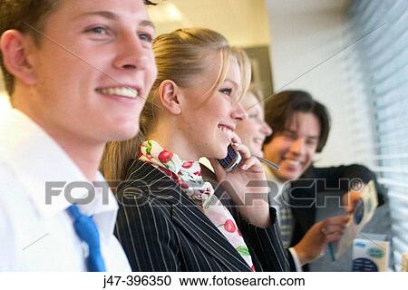4 young business people standing in a line looking out of the window, selective focus View Large Photo Image Stock Image - 4 young business people standing in a line looking out of the window, selective focus. Fotosearch