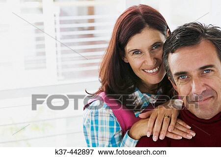 40-45 year old Caucasian couple relaxing in living room View Large Photo Image Stock Photo - 40-45 year old Caucasian couple relaxing in living room. Fotosearch