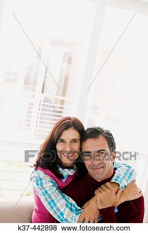 40-45 year old Caucasian couple relaxing in living room View Large Photo Image Stock Photo - 40-45 year old Caucasian couple relaxing in living room. Fotosearch