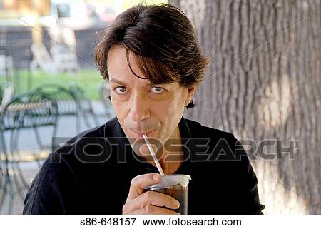 40-45 year old caucasian male, sipping iced coffee, at an outdoor caf? View Large Photo Image Stock Photo - 40-45 year old caucasian male, sipping iced coffee, at an outdoor caf?. Fotosearch