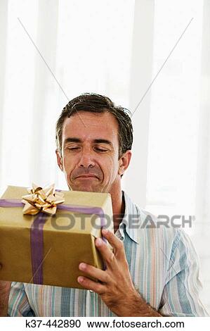 40-45 year old Caucasian man with gift box View Large Photo Image Stock Image - 40-45 year old Caucasian man with gift box. Fotosearch
