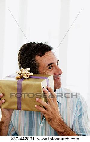 40-45 year old Caucasian man with gift box View Large Photo Image Stock Image - 40-45 year old Caucasian man with gift box. Fotosearch