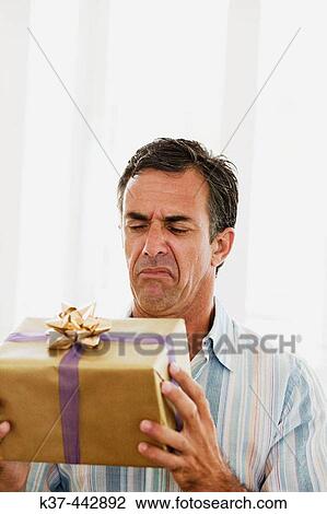 40-45 year old Caucasian man with gift box View Large Photo Image Stock Image - 40-45 year old Caucasian man with gift box. Fotosearch