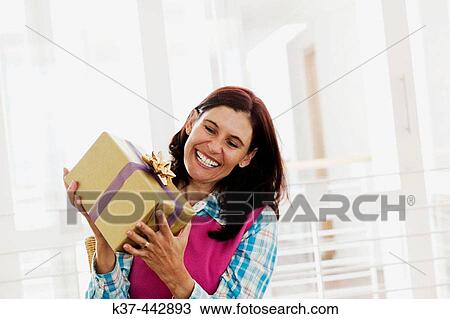 40-45 year old Caucasian woman with gift box View Large Photo Image Stock Image - 40-45 year old Caucasian woman with gift box. Fotosearch