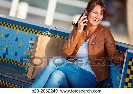 40 Woman talking on the phone. Shopping on the street. Donostia. San Sebastian. Gipuzkoa. Basque Country. Spain. View Large Photo Image Stock Photo - 40 Woman talking on the phone. Shopping on the street. Donostia. San Sebastian. Gipuzkoa. Basque Country. Spain.. Fotosearch