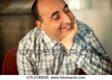 40-year-old Caucasian man, with hand on his chin, smiling and with positive attitude. View Large Photo Image Stock Photograph - 40-year-old Caucasian man, with hand on his chin, smiling and with positive attitude.. Fotosearch