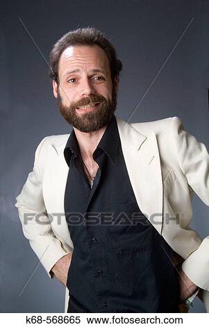 Stock Photography - 40 year old man in white suit. Fotosearch