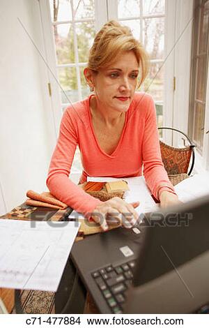 Picture - 40's cacusian interior decorator working at home.. Fotosearch